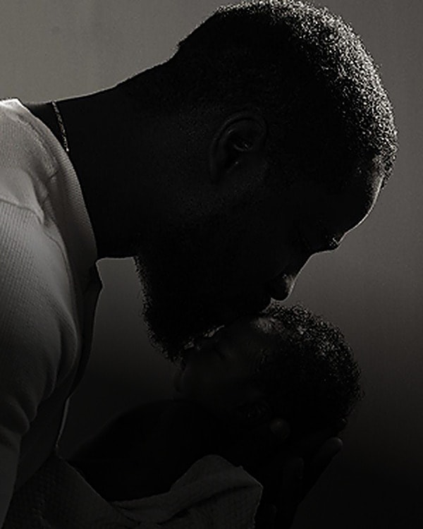 Father holding his newborn close