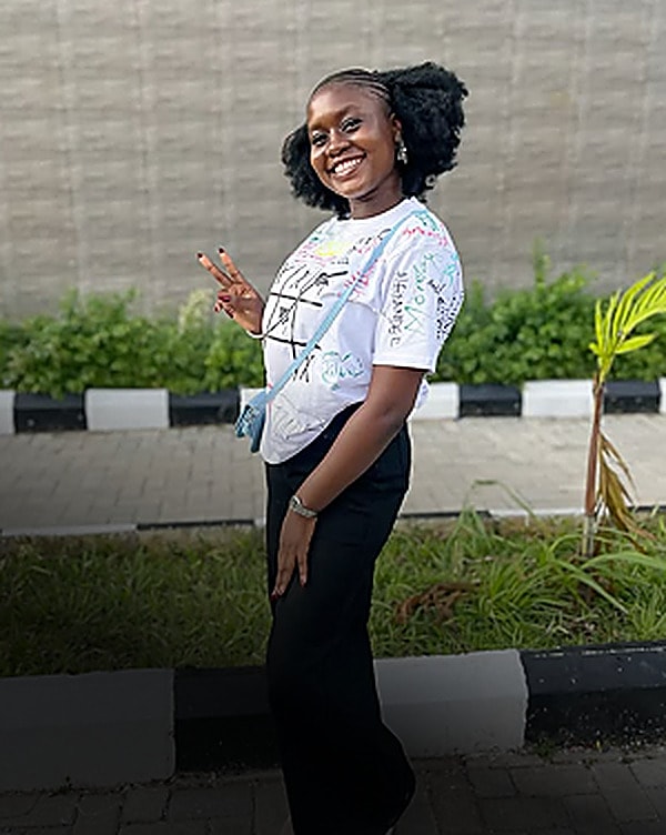 Smiling student in a signed white shirt